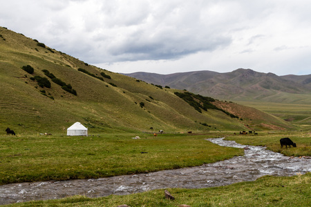 yurt by the stream in the mountains of Kazakhstanの写真素材