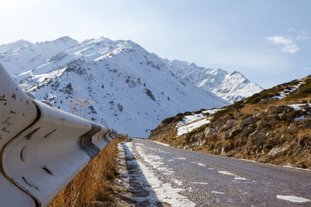 Dangerous road in the mountains in winterの写真素材
