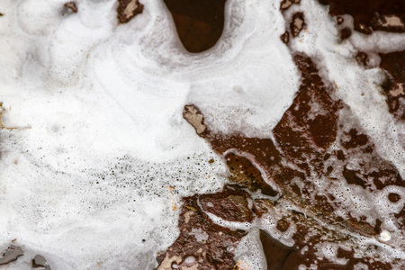 foam from detergent on the surface of the stoneの写真素材