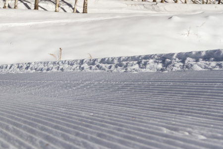 snowcat trace of snow at the edge of the trackの写真素材
