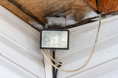 halogen spotlight with the wiring in the corner of the houseの写真素材