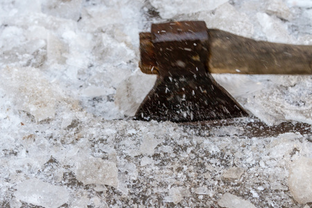 ax chopping ice from a large influx in the landの写真素材