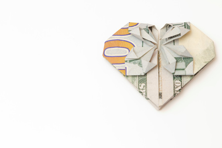 dollar bill folded heart on a white backgroundの写真素材