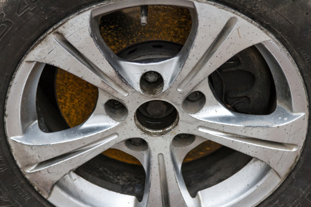 Old alloy wheel with rust on the brakes