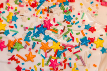 White frosting and sprinkling on the Easter cakeの写真素材