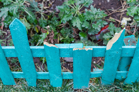 broken fence of thin boards in the gardenの写真素材