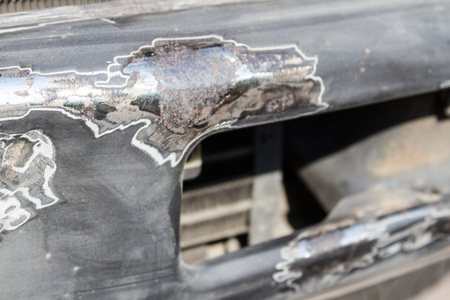rust removal of an old metal bumper from an SUV