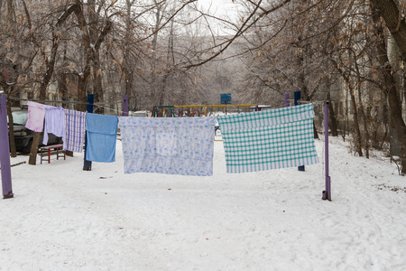 drying clothes on the street along the housesの写真素材