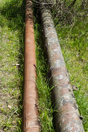 rusty pipes on the ground for water supplyの写真素材
