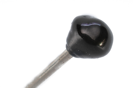 Extreme macro of a needle with black head isolated on white background; focus stack imageの写真素材