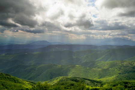 On the high peak, mountain landscape on cloudy day.