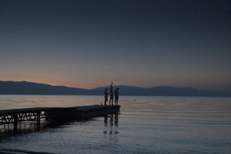 Kids playing on quiet late sunset under the starsの写真素材
