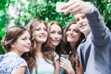 Kiev, Ukraine, July 2015: happy students take a selfie in the parkのeditorial素材