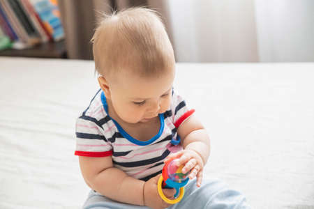 adorable baby played with a toy to develop fine motor skillsの写真素材