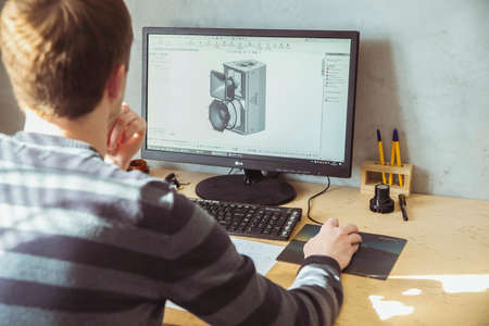 Bila Tserkva, Ukraine, March 2021: Design engineer develops a loudspeaker on a computerのeditorial素材