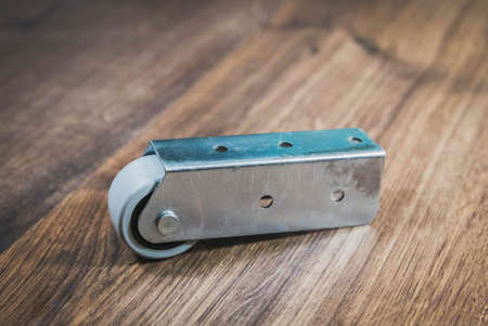 Metal furniture leg with castor. Place for textの写真素材