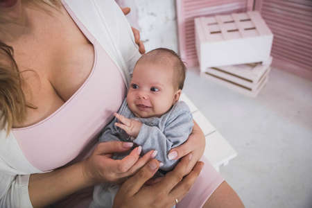 married couple holds in arms tiny smiling daughterの写真素材