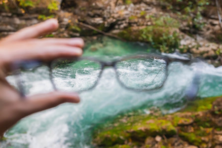 seething mountain river in Slovenia through glassesの写真素材