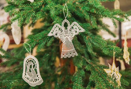 Embroidered Christmas toys in the form of a angel, bell and stars on the treeの写真素材