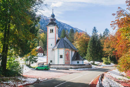 Triglav National Park, Slovenia, October 2020: Church of the Holy Spirit between the Alpine Range and Lake Bohinj in Sloveniaのeditorial素材