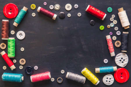Frame made of buttons and spools of threadの写真素材