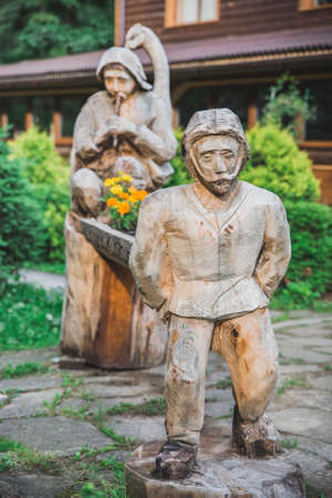 Shevchenkovo ââvillage, Ukraine, June 2018: Flower pots in the form of statues of people carved from woodのeditorial素材