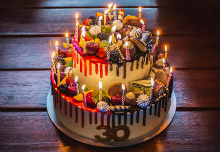 Cake decorated with berries and edible moneyの写真素材