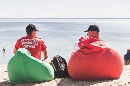 Glebovka, Ukraine, August 2020: Rescuers sit in soft chairs by the seaのeditorial素材