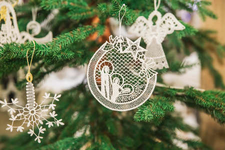 Embroidered Christmas toys in the form of a snowflake, angel and the birth of Christ on the treeの写真素材