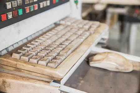 Old dirty keyboard to control a CNC machine. Focus in the foregroundの写真素材