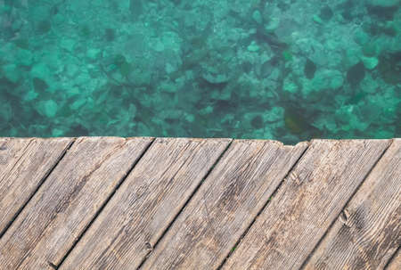 Marine background. Old wooden pier and turquoise waterの写真素材
