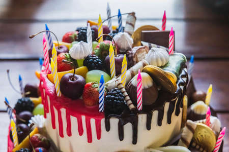 Cake decorated with berries and edible money
