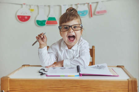 Charming child plays pretending to be a teacherの写真素材