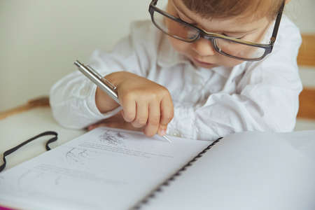 Charming child plays pretending to be a teacherの写真素材