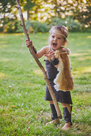 Cute baby dressed in the clothes of primitive peopleの写真素材