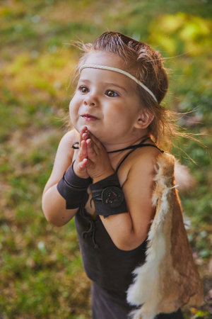 Cute baby dressed in the clothes of primitive peopleの写真素材