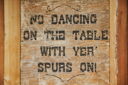 Old wooden tablet in a wild west saloonの写真素材