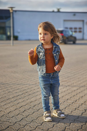 Stylish child playing in the parking lotの写真素材