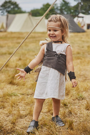 Charming child in primitive clothes at the viking festival in Denmarkの写真素材