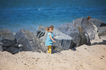 Charming child walking on the beach in Denmarkの写真素材
