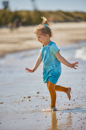 Charming child playing on the beach in Denmarkの写真素材