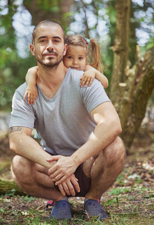 charming child hugging father in the yard in Denmarkの写真素材