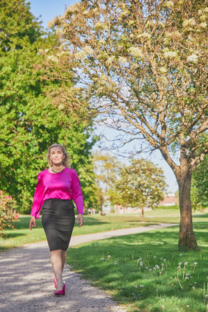 Hammel, Denmark, May 28, 2023: Beautiful woman walking in the parkのeditorial素材