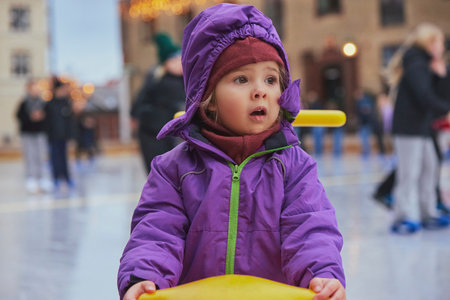 Charming child on an ice rink in Denmarkの写真素材