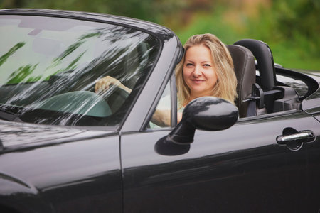 Attractive woman in a cabriolet in the Netherlandsの写真素材