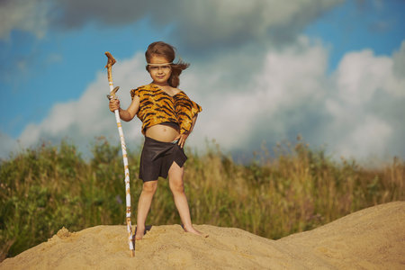 Cute baby dressed in the clothes of primitive people