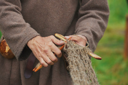 Fisherman weaving a net at a Viking festival in Denmarkの写真素材