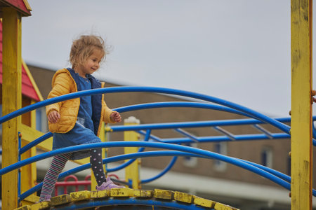 Charming child playing on a playground in Ringkobing Denmark