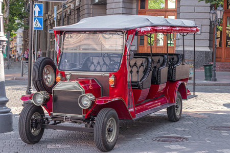 sightseeing car of red color standing in the open air close-up in the city of odessa.の写真素材