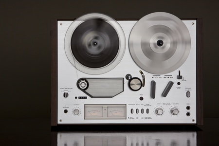 Vintage Reel-to-Reel stereo tape deck recorder closeup on the dark backgroundの写真素材
